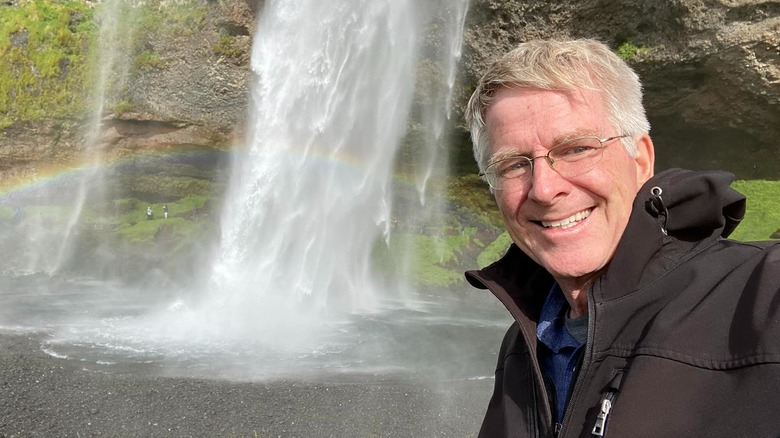 Travel expert Rick Steves in front of waterfall