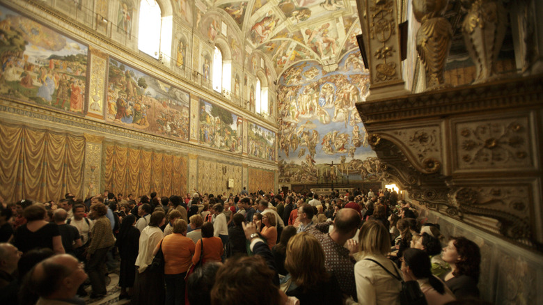 Tourists inside the Sistine Chapel in Rome