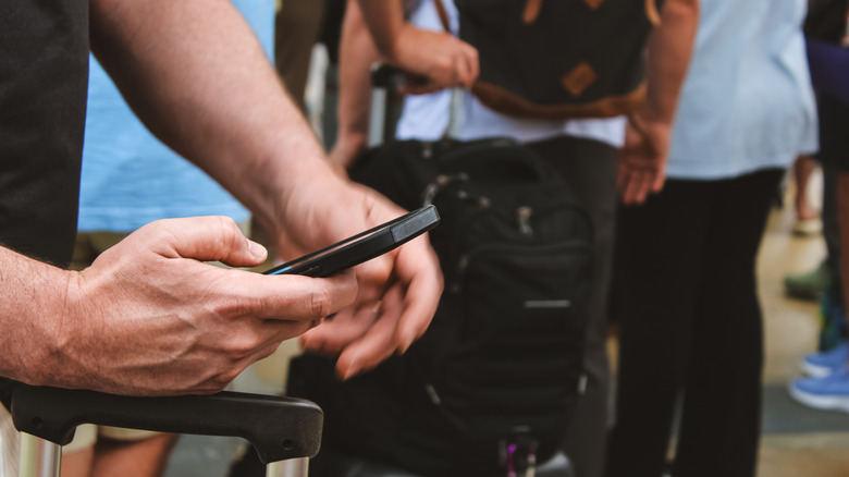 Traveler on their phone, looking up information