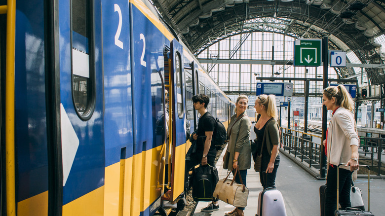 A group of friends getting on a train