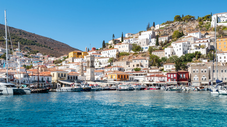 Harbor of Hydra, Greece, an island off the mainland, on a sunny day with boats and colorful buildings