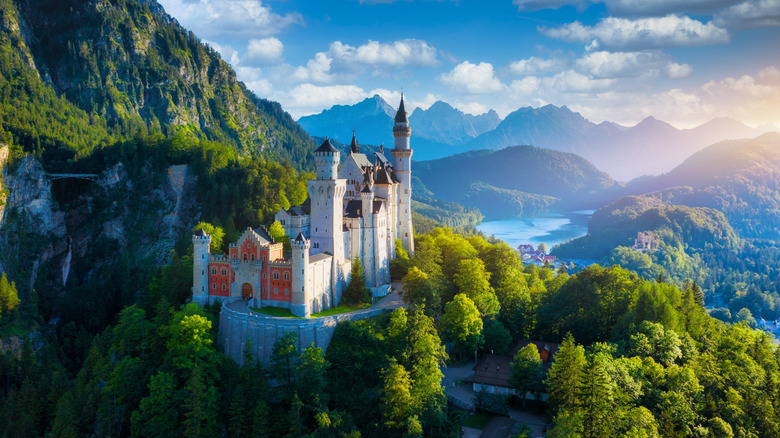 Famous Neuschwanstein Castle surrounded by the mountains and forests of Bavaria, Germany