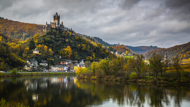 Cochem along the Mosel River, crowned by a castle, during a gloomy autumn day