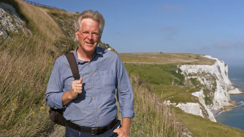 Rick Steves standing on a grassy cliff in Dover, England