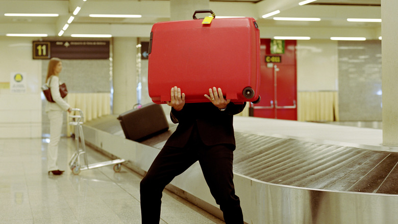 Traveler struggling with a large suitcase