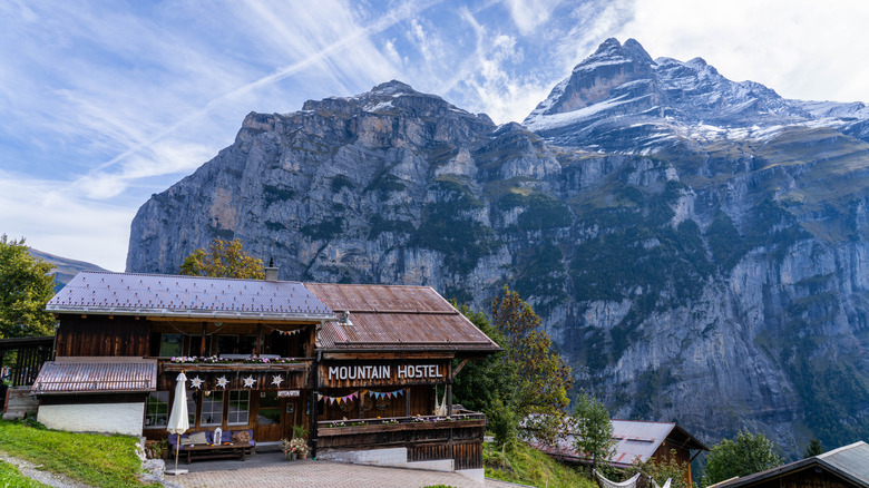 Mountain Hostel in the Alps with a snow-covered peak in the background in Gimmelwald, Switzerland