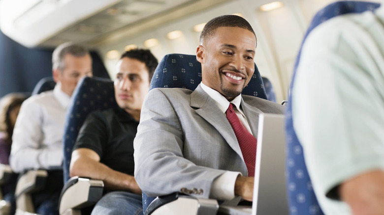 People sitting in the economy section in a plane
