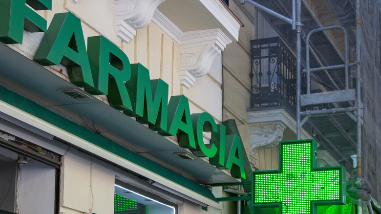 A pharmacy sign in Italy on a building