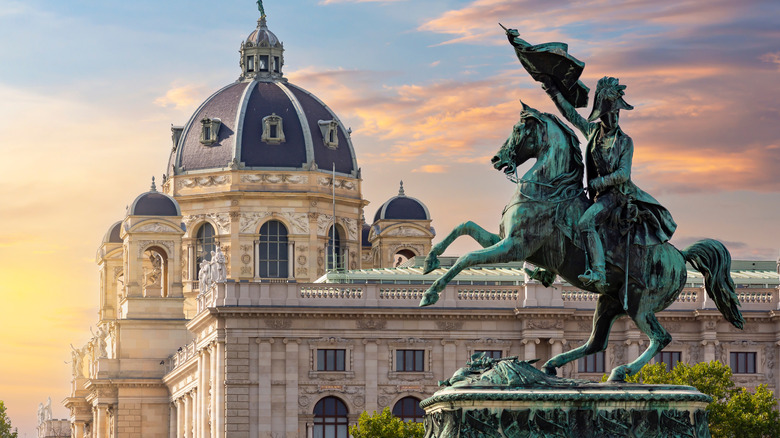 Statue of Archduke Charles on Heldenplatz square and Museum of Natural History dome at sunset, Vienna, Austria