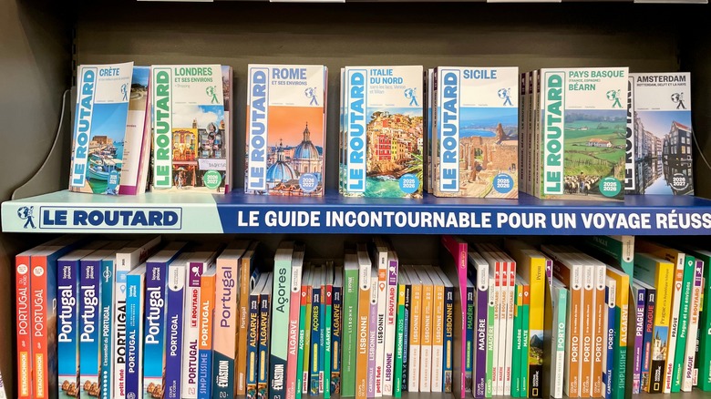 Bookshelf with travel guidebooks in a bookstore.