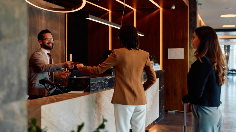 Female guest checking in at a hotel lobby