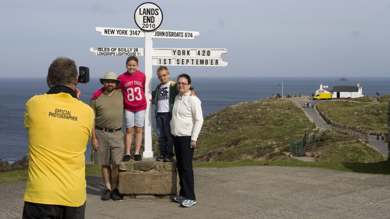 A family is photographed by a professional photographer in Land's End, England