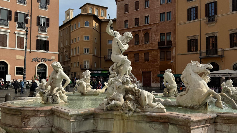 Close-up of the Fontana dei Quattro Fiumi with buildings in the background