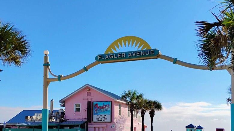 Road sign for Flagler Ave, with Breakers Ocean Front Restaurant behind it