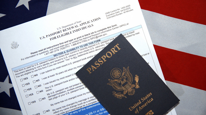 United States passport and passport renewal application form with American flag in background.