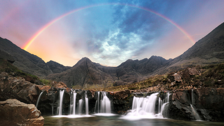 Rainbow over Fairy pools waterfall in Isle of Skye