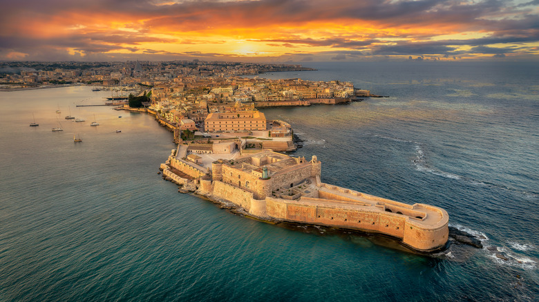 An aerial view of the island of Ortigia and Syracuse at sunset