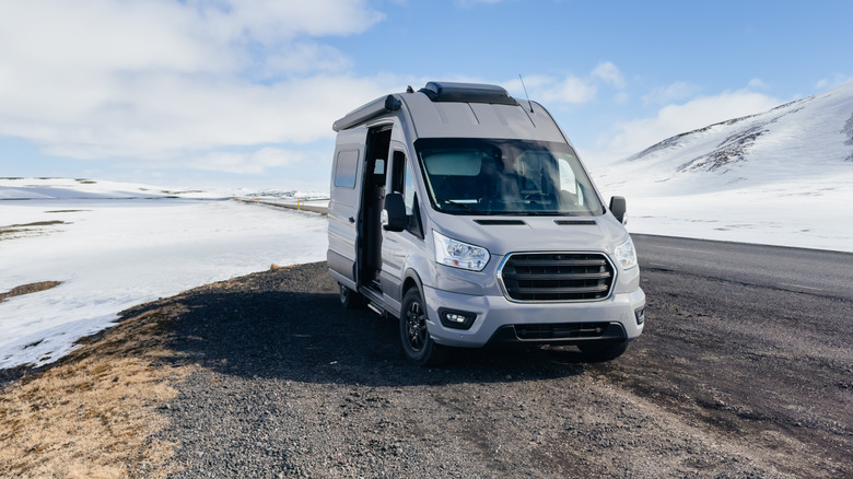Camper van on the road in a snowy landscape