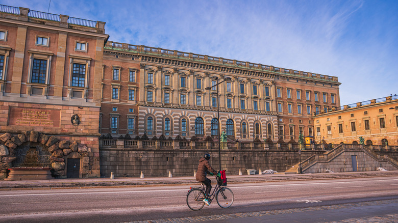 A cyclist rides in front of the Royal Palace in Stockholm