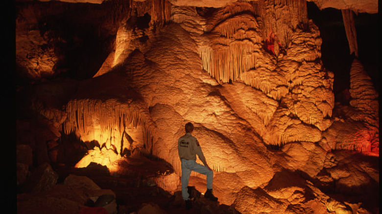 A man looking at towering rock formations inside of Cumberland Caverns