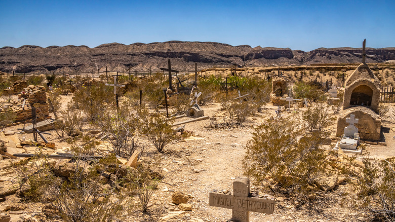 crosses mark the graves in Terlingua's cemetary with mountains in background