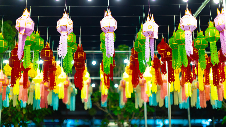 Line of colorful lanterns lit up at a night market in Chiang Mai, Thailand
