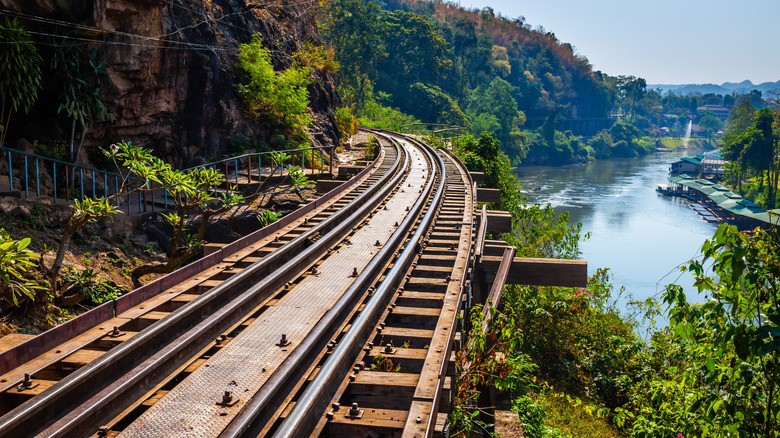 Railroad bridge following a river in Thailand