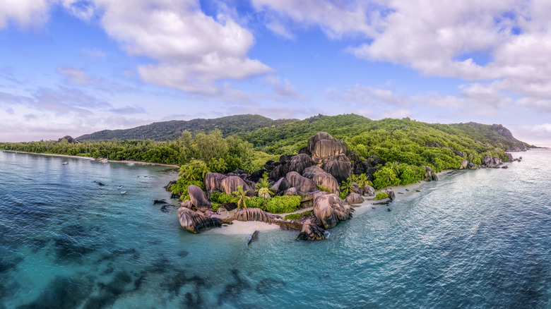 Aerial view of the shoreline of Anse Source d Argent, the Seychelles, with granite rock formations in the foreground