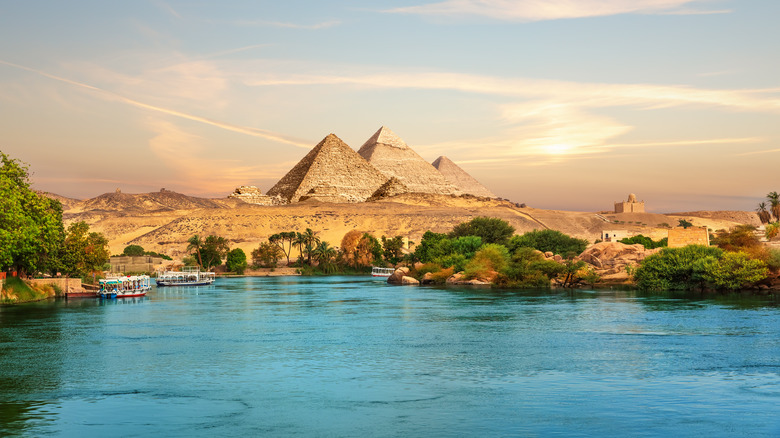 View on the Nile and the boats at sunset in the Aswan desert near the Pypamids of Egypt.