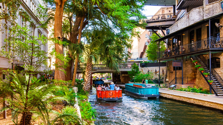 Tourist boats sail along the San Antonio River Walk