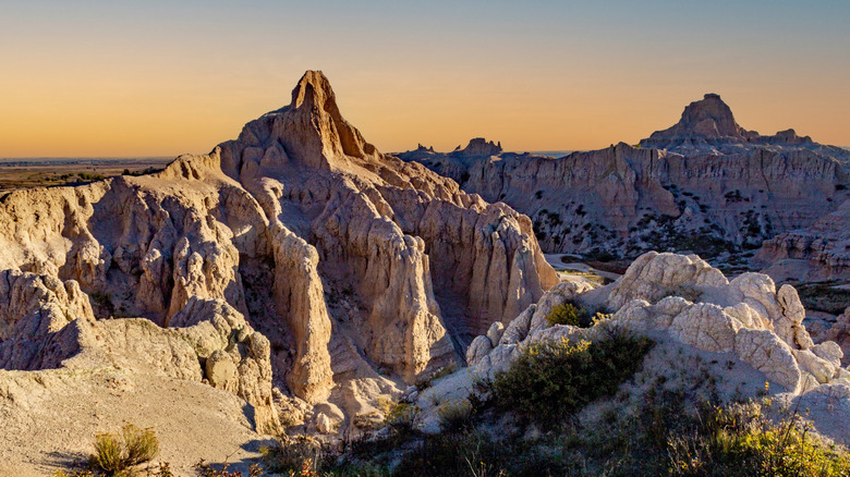 Pinnacle rock formation as seen from the Notch Trail, Badlands National Park, South Dakota with an orange sky in the background