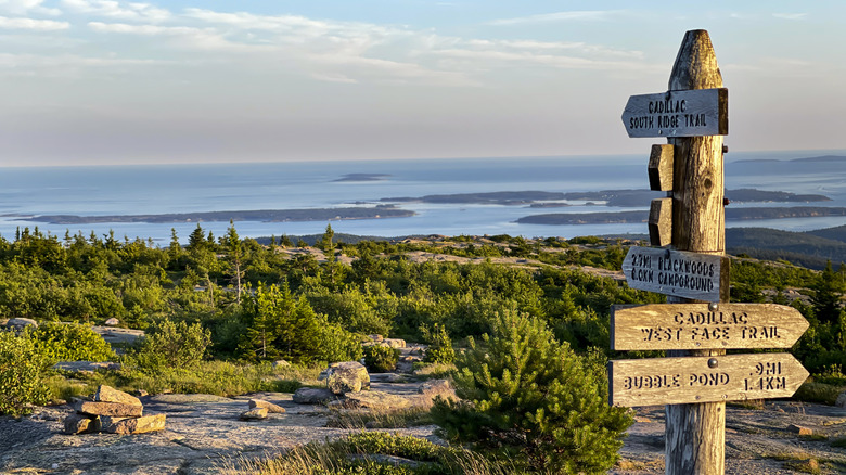 Directional sign overlooks the ocean in Bar Harbor from the top of Cadillac Mountain in Acadia National Park.