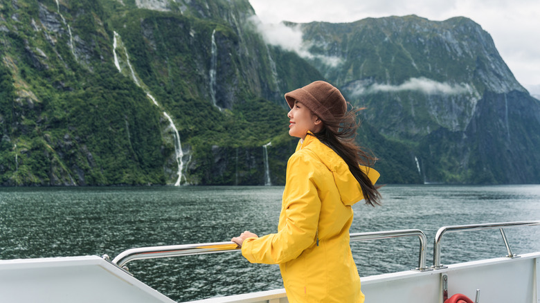 A traveler soaking up the views at Piopiotahi in New Zealand