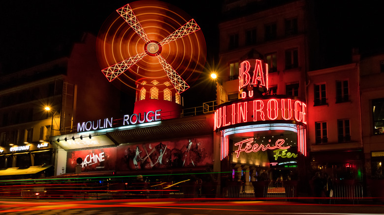 Exterior of the lit up Moulin Rouge at night