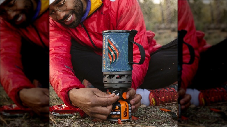 A man uses a Jetboil Flash 1.0 boiler