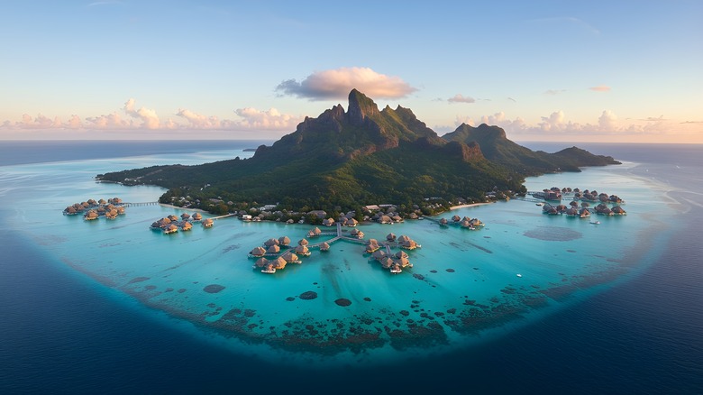 Aerial view of Bora Bora island and its overwater villas at sunrise