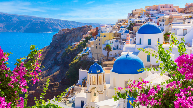 Traditional blue-domed buildings overlooking the ocean in Santorini