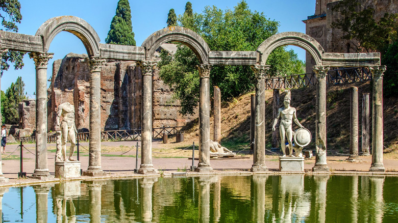 Columns, arches, and statues reflecting onto a pond at Hadrian's Villa in Tivoli