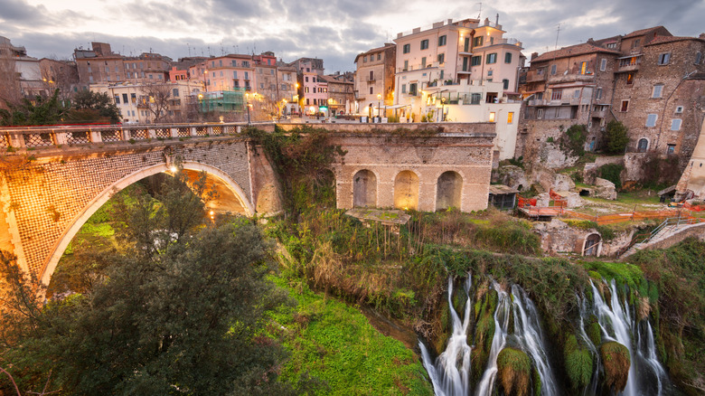 Tivoli at dusk, with water streaming through a green hill