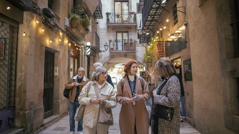 A group of travelers walking along a street in Barcelona, Spain