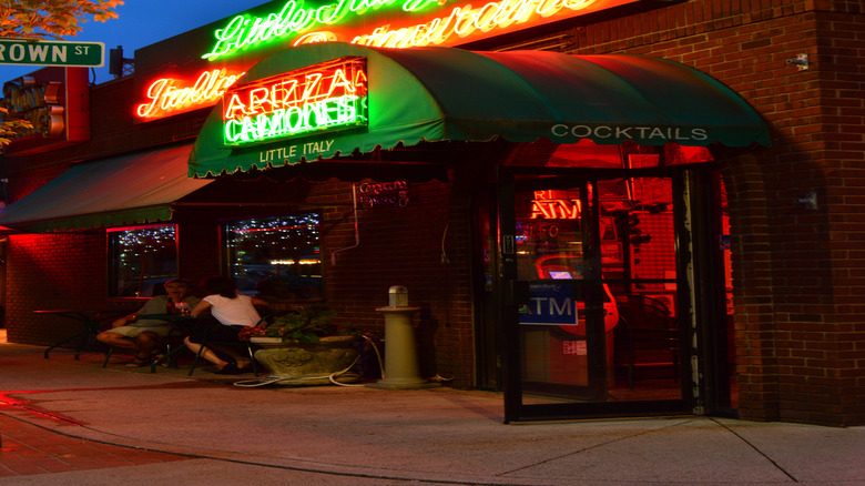 View of a restaurant neon sign reading "Little Italy Italian Restaurant" lit up in Wooster Square, New Haven, Connecticut's Little Italy