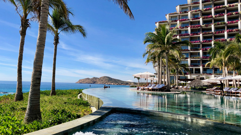 Grand Velas Resort in Los Cabos, Mexico, with a pool and flower-lined balconies along the Pacific
