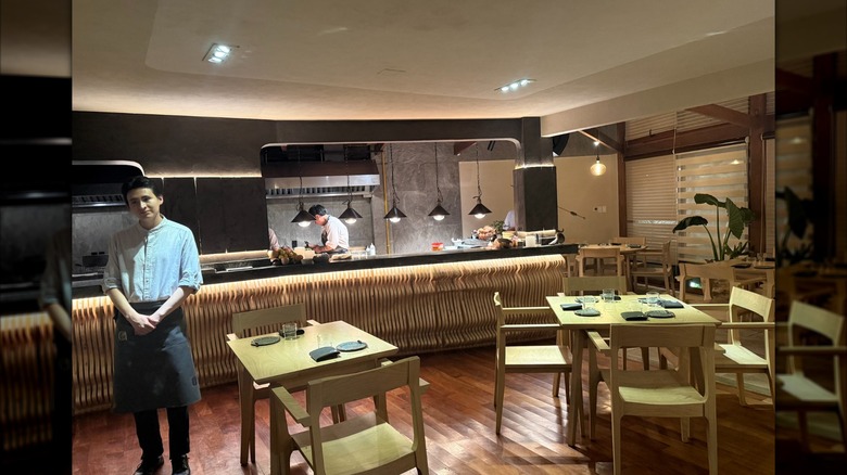 Dining tables and open kitchen inside Arami