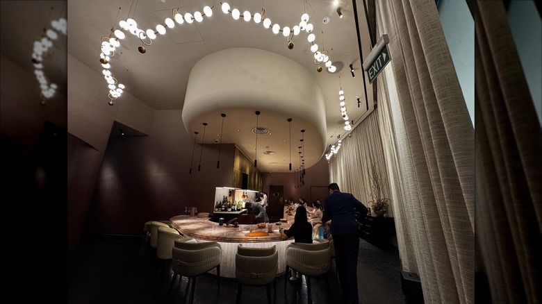 People sitting around open kitchen at Araya