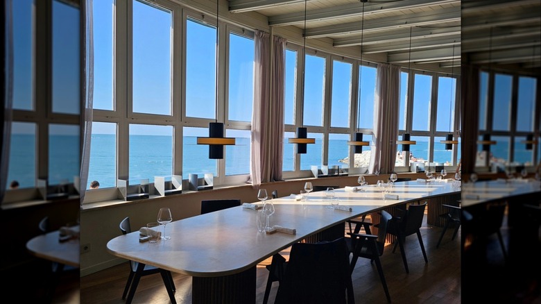 Table surrounding by oversized windows at Da Lucio