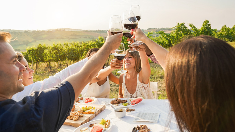 happy people having fun drinking and eating together