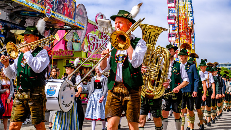 Participants with traditional clothes and musical instruments at a parade in Munich