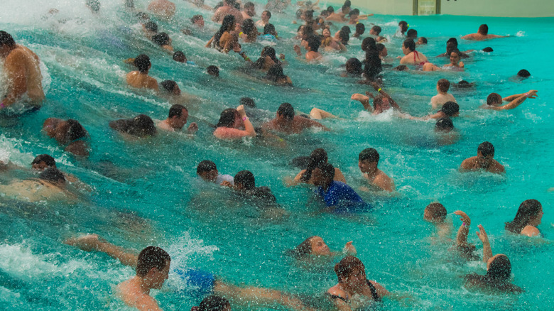 Guests enjoying an indoor wave pool in the Wisconsin Dells as waves surge