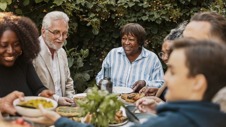 Friends and family around an outdoor dinner table