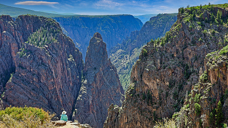 A spectator observing the rocky spires of Black Canyon of the Gunnison National Park near Gunnison, Colorado